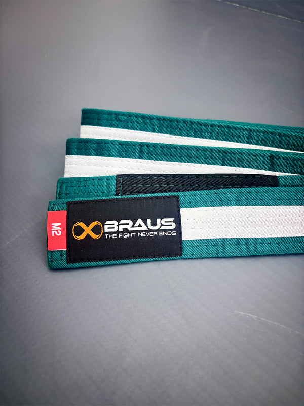 Green/White belt with white stripes and Braus logo on a gray surface