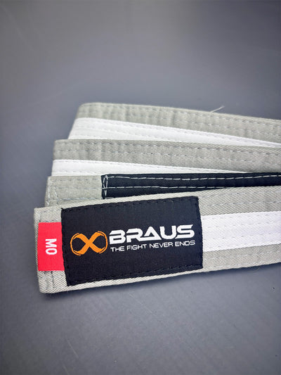 Grey/White martial arts belt with Braus brand label on a gray background