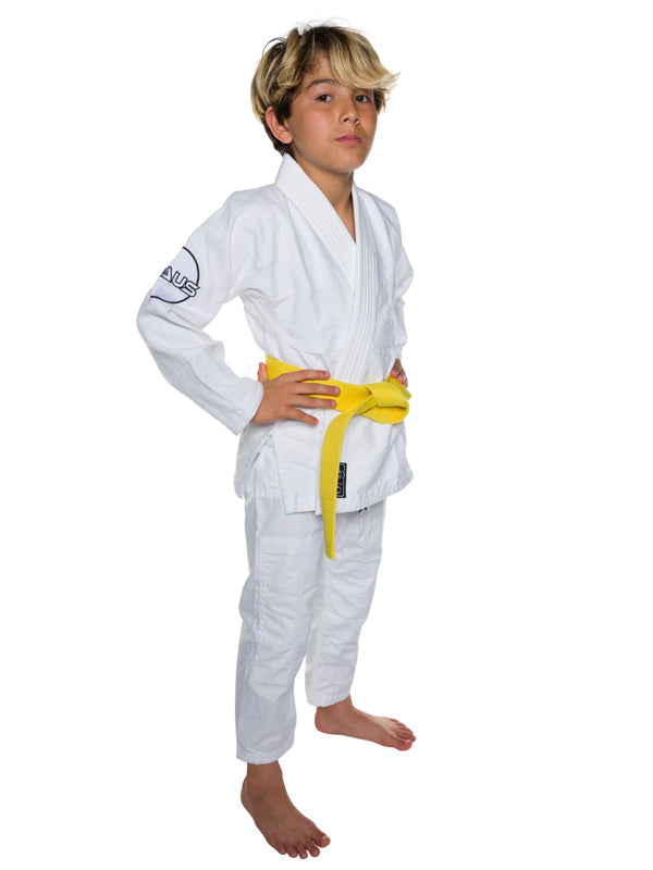 Child wearing a white martial arts gi with a yellow belt on a white background