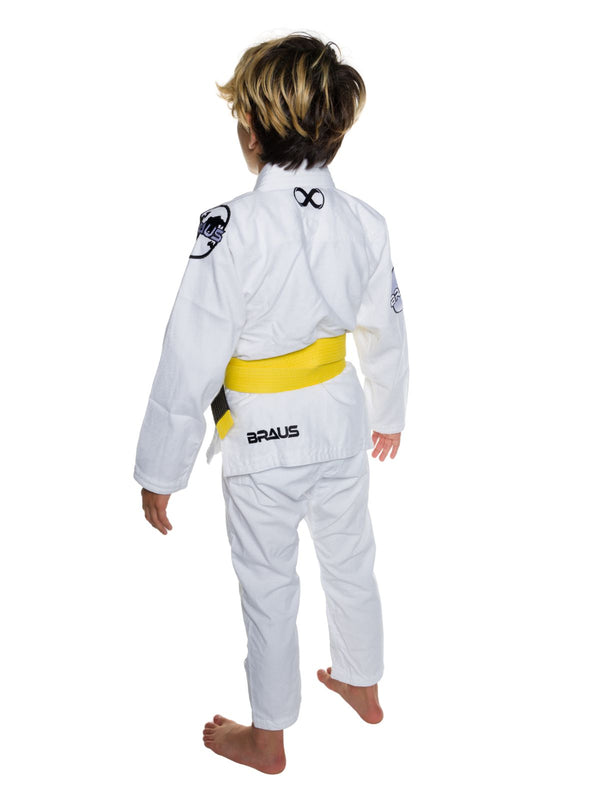 Child wearing a white BJJ gi with a yellow belt on a white background