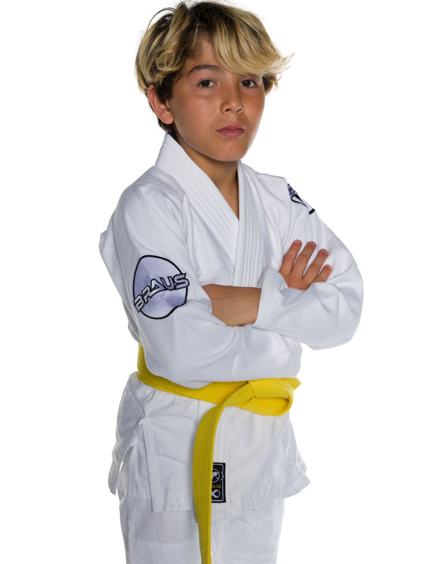 Child wearing a white martial arts uniform with a yellow belt on a white background