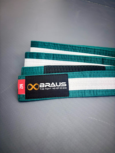 Green/White belt with white stripes and Braus logo on a gray surface