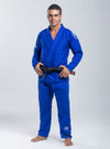 Man wearing a white martial arts uniform with a belt on a gray background