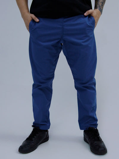 Mid Blue Color Person wearing blue pants and black shoes on a plain background