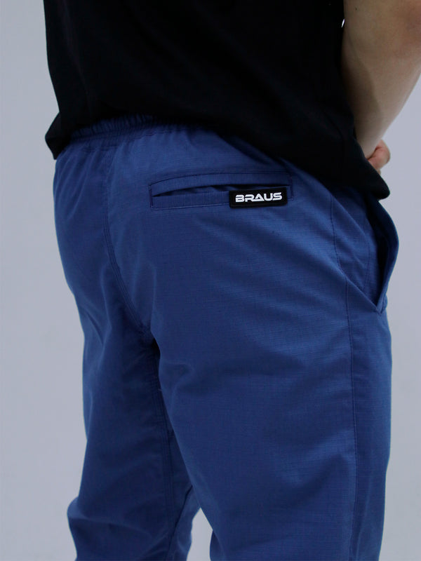 Mid Blue Color pants with a brand logo on a gray background